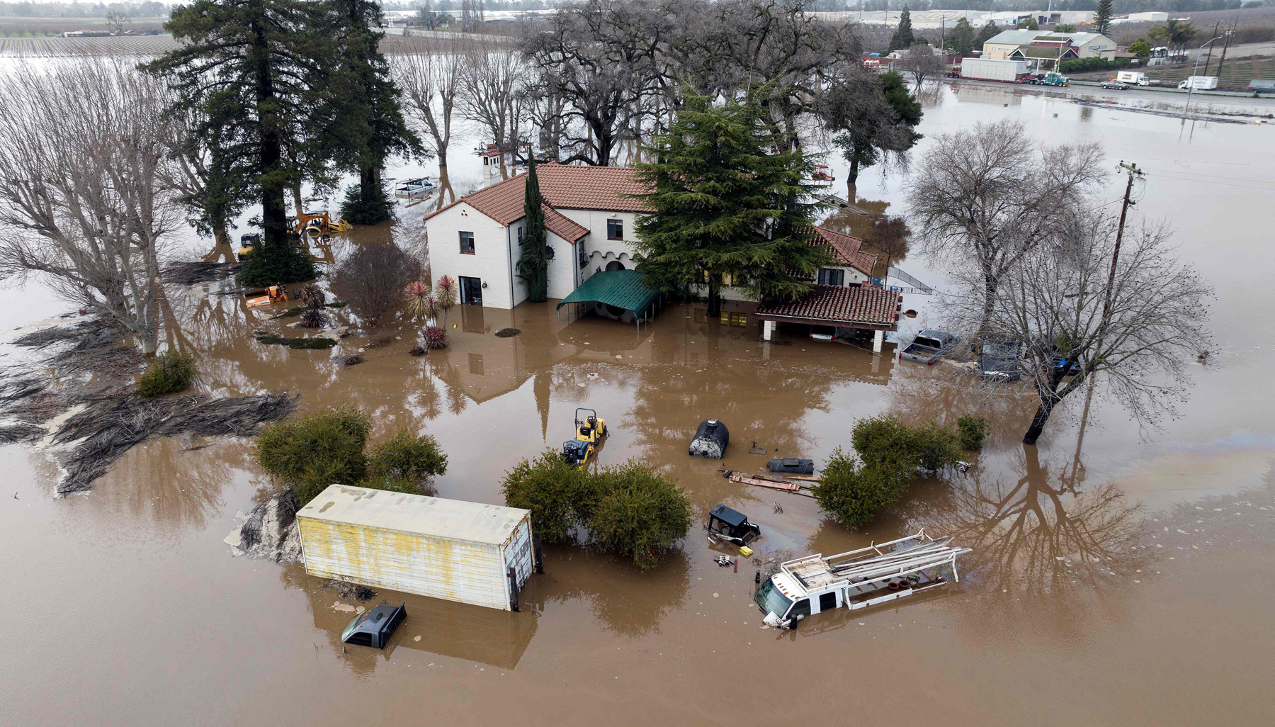 This aerial view shows a flooded home partially underwater in Gilroy, California, on January 9, 2023. - A massive storm called a bomb cyclone